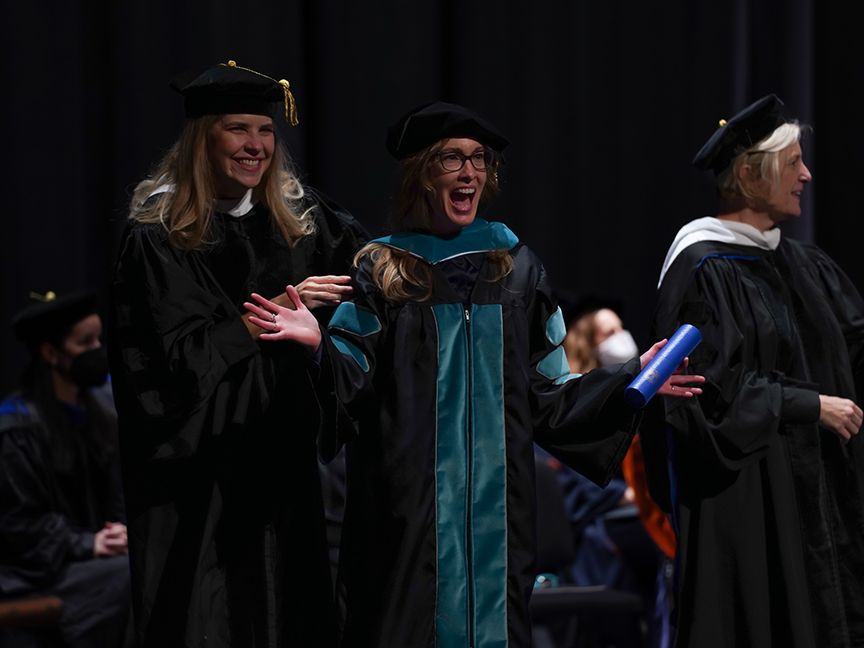 ATSU DPT student in line, excited to walk across the stage at graduation