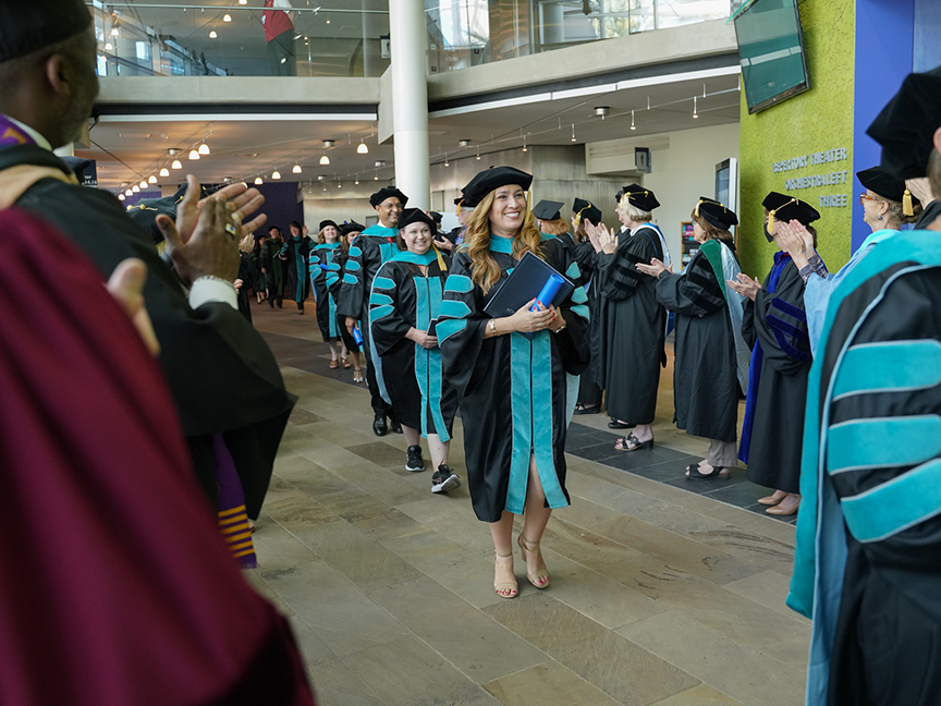 ATSU DPT graduates reuniting with their families in a common area after graduation