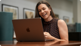 A Person Smiling at a laptop