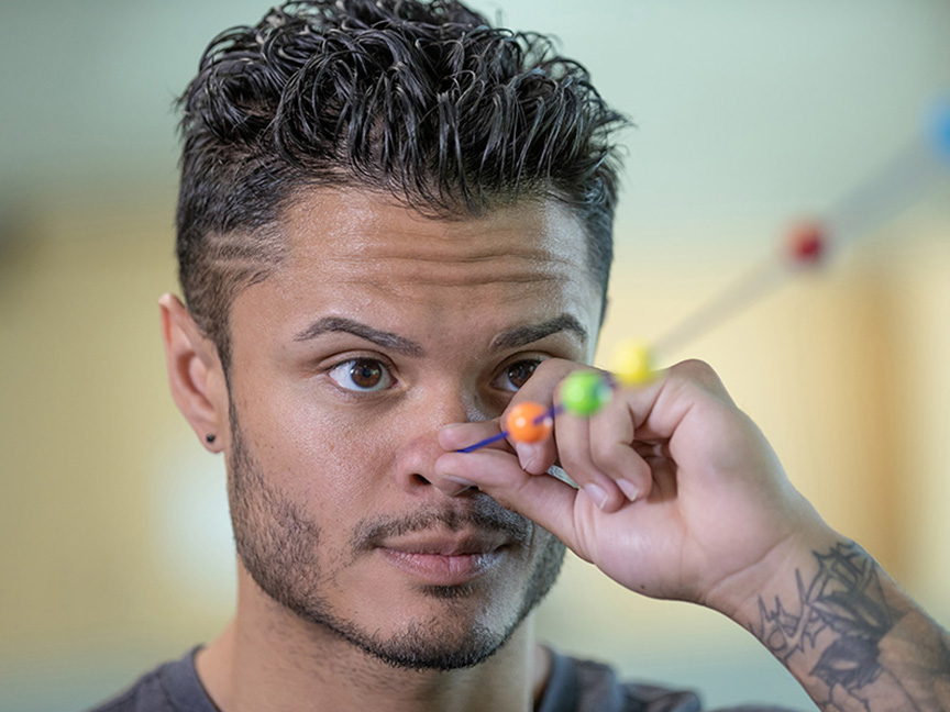 ATSU DAT student performing a depth perception exercise by holding an object in front of his nose