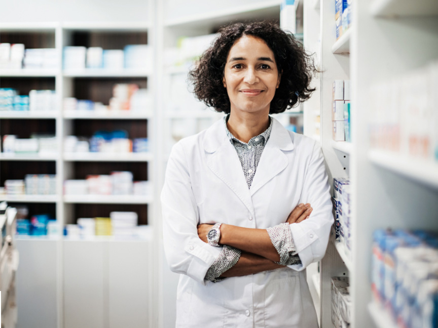 Healthcare student smiling at the camera in a healthcare setting, showcasing enthusiasm and professional development in the field.