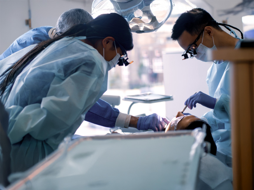 Master of Public Health dental clinicians working together on a patient, highlighting teamwork and advanced clinical care skills.