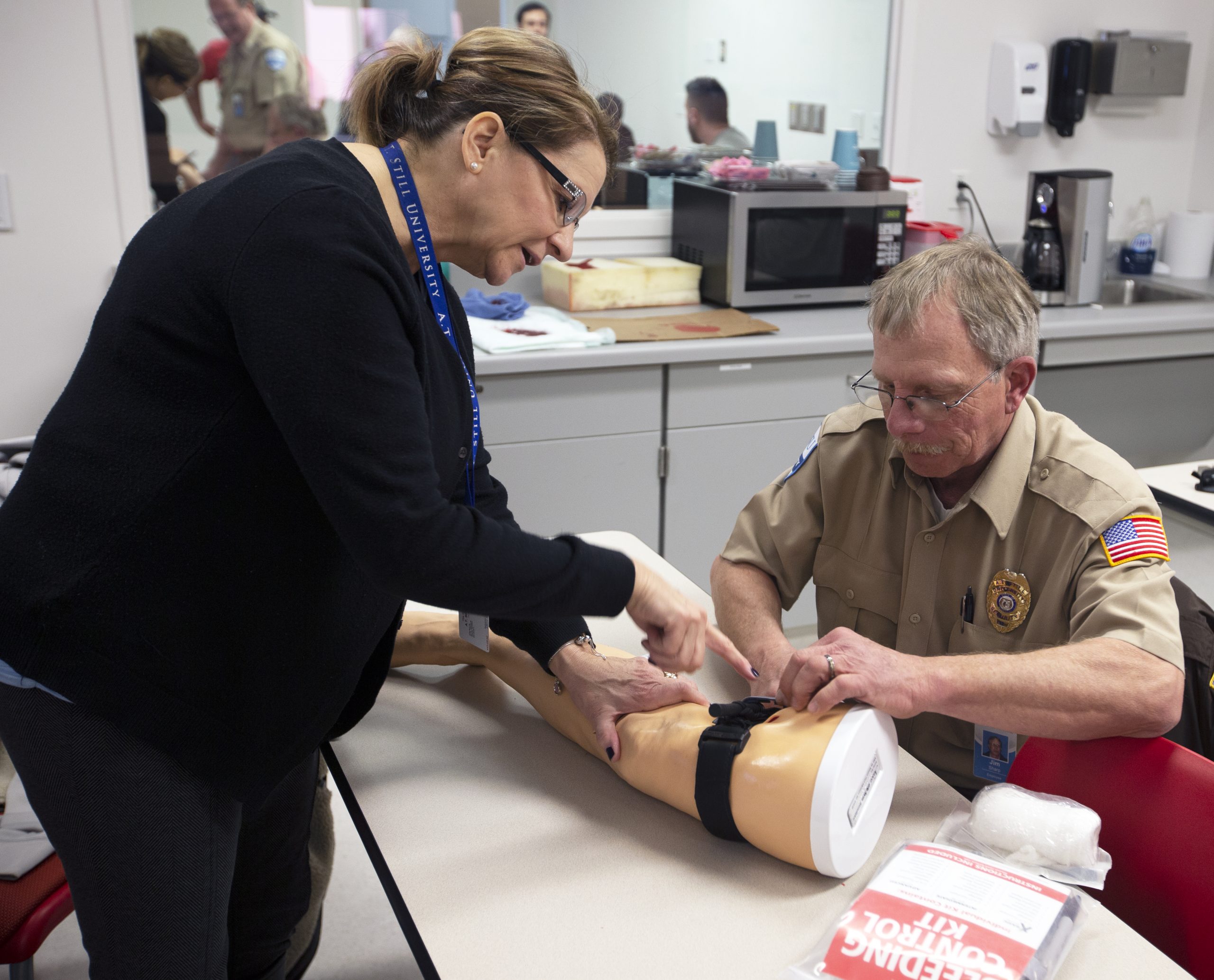 Using tourniquets at Stop the Bleed training.