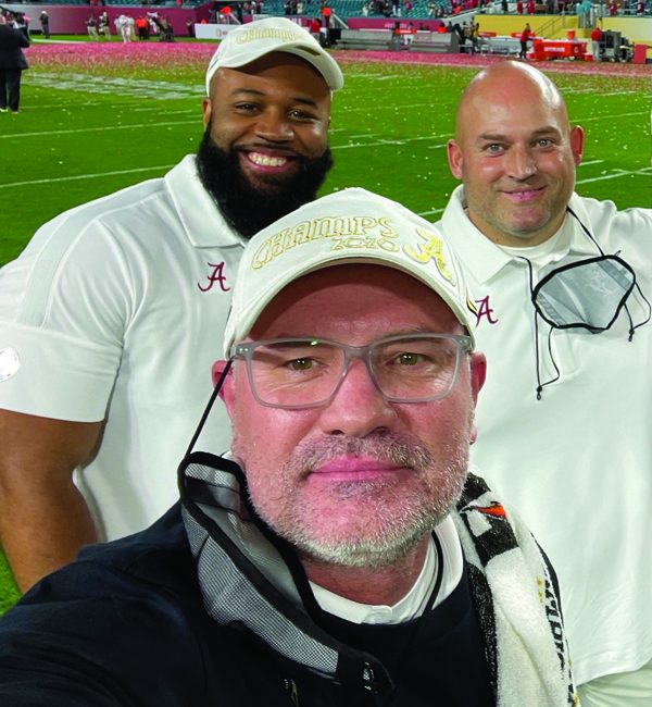 From left, Paul Constantine, Dr. Matt Rhea,
and David Ballou take a selfie after Alabama football’s
win in the 2020 NCAA football national championship
game.