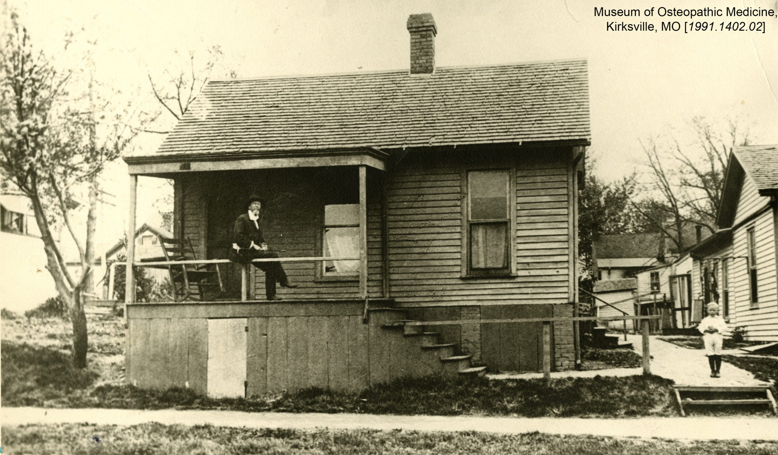 Dr. Still sits on the porch of the first school of osteopathic medicine. Museum of Osteopathic Medicine, Kirksville, Missouri [1991.1402.02]